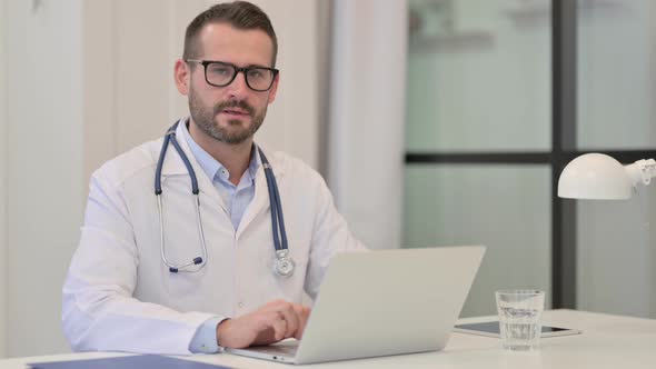 Denying Male Doctor with Laptop Showing No Sign By Finger