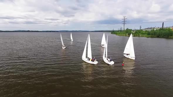 Aerial view of Boats on the city pond with industrial landscape