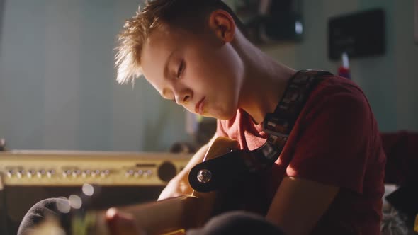 Serious Teenager Playing Electric Guitar