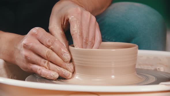 Pottery - the Master Is Raising the Walls of the Clay Bowl with His Hands on the Potter's Wheel