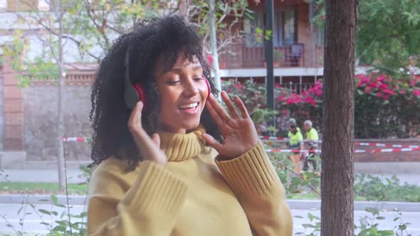 Funny Young Brazilian Woman Dancing in the Street Listening to Music