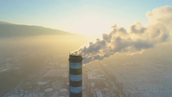 Industrial Smoke in Sunset Light with City in Background