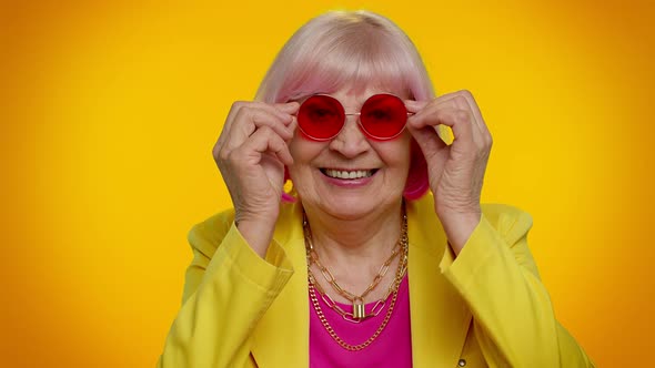 Happy Playful Stylish Senior Granny Woman in Sunglasses Blinking Eye Looking at Camera with Smile