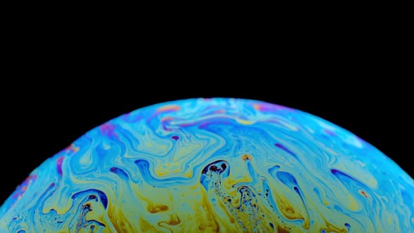 Multicolored Rainbow Colors of a Single Soap Bubble That Looks Like a Fantasy Planet Isolated