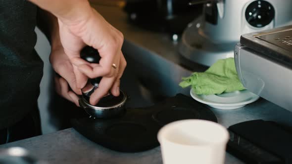 Process of making espresso in a coffee machine. Barista making latte in  specialty coffee shop.