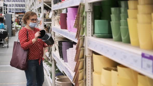 Senior Woman Choosing Flower Pot in a Store