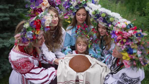 High Angle View of Charming Ukrainian Girl Looking at Camera Showing Loaf of Bread on Ukrainian