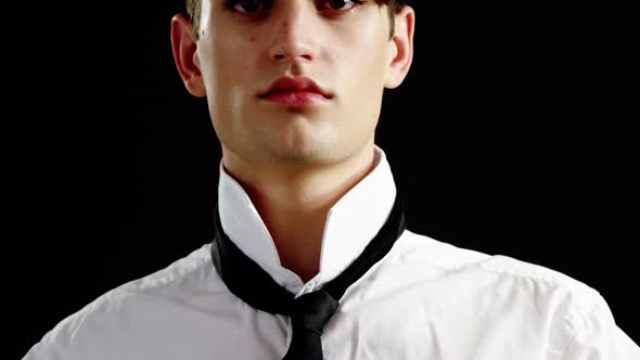 Androgynous man adjusting his tie