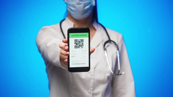 Woman Doctor in Medical Uniform Showing Vaccination Passport with Qr Code on Phone International