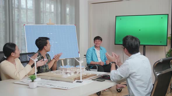 Asian Man Engineer In Wheelchair With Solar Cell Succeed Presenting About The Green Screen TV