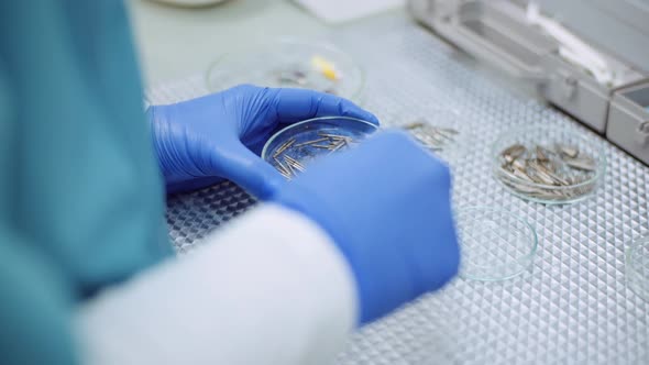 Doctor Sorts Medical Instruments at Healthcare Clinic