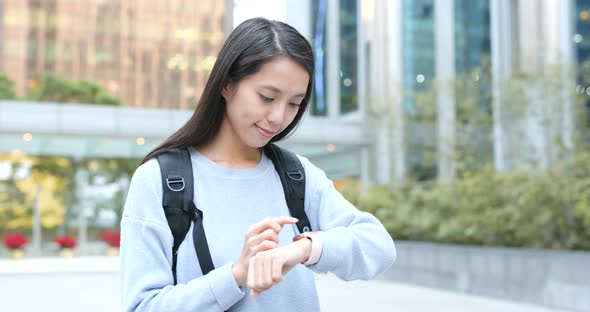 Woman use of smart watch in city