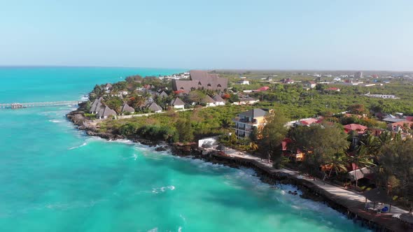 Aerial Tropical Landscape of Zanzibar Waves Hit Reef on Hotels Coastline Palms