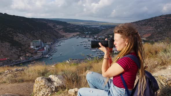 Girl with Dreadlocks Takes Pictures of River in Gorge