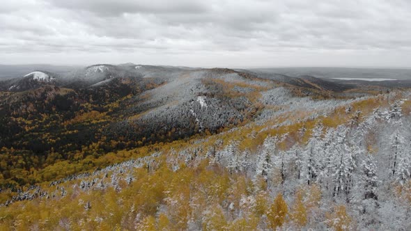 Aerial  View of Mountains Capped By First Snow