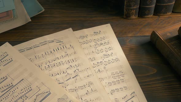 Hand Written Sheets Of Music On The Table