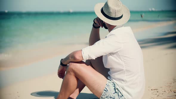 Man On Vacation.Tanned Man Relaxing Vacation Caribbean Tropical Beach. Summer Sunbathing On Resort