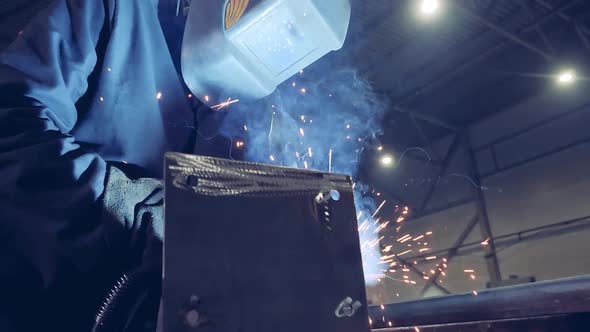 One Person Uses Welding Machine at a Plant