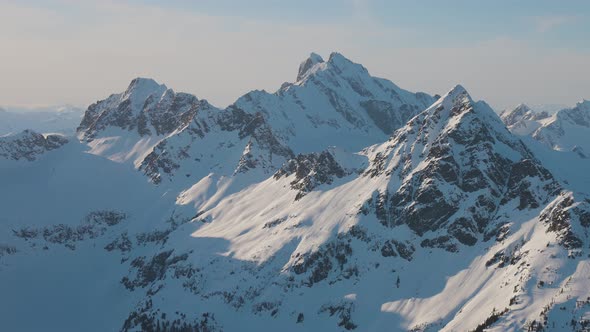 Aerial View From an Airplane of Beautiful Snowy Canadian Mountain Landscape