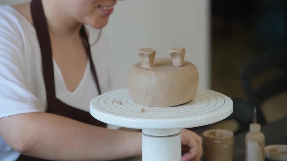 Young Woman Attaching Clay Product Part To Future Ceramic Product. Pottery Workshop.