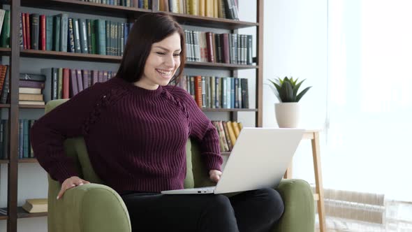 Excited Woman Celebrating Success, Working on Laptop