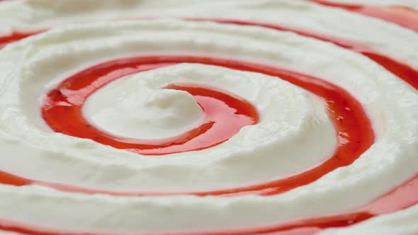 Close up of yogurt with fruit jam, curd cream swirl with berry topping