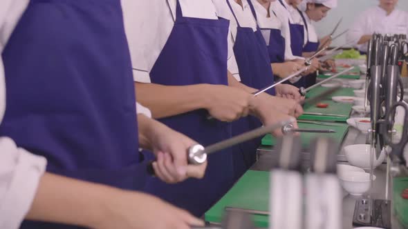 Group Of People At Cooking Classes Sharpening Knife
