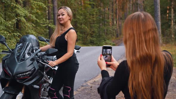 Smiling Women Friends Taking Photos on Motorbikes in the Forest  Blonde Woman Posing