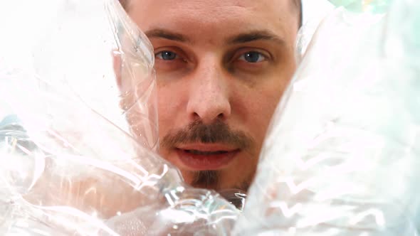 Face of a Man in a Pile of Plastic