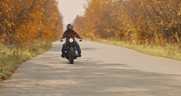 Guy Biker Rides on the Highway on a Motorcycle