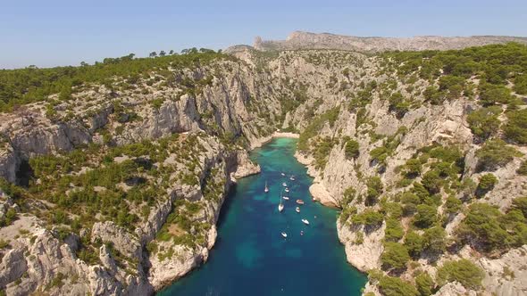 Aerial travel drone view of clear green water, cliffs of Cassis, Mediterranean Sea, Southern France.