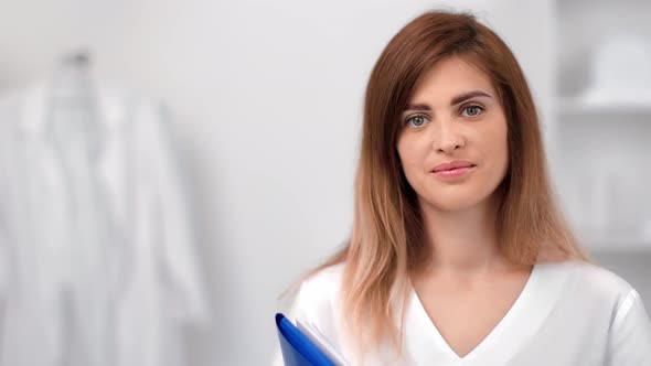 Medium Close Up Portrait of Woman Professional Doctor in White Uniform Posing at Medical Clinic