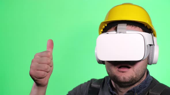 Young European Worker Uses Virtual Reality Goggles on Chromakey Background