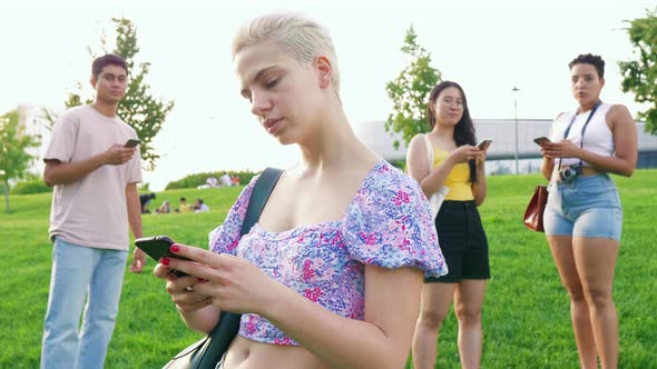 Slow motion young woman outdoor using smartphone hand hold smiling chatting, sharing or surfing web