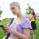 Slow motion young woman outdoor using smartphone hand hold smiling chatting, sharing or surfing web - VideoHive Item for Sale