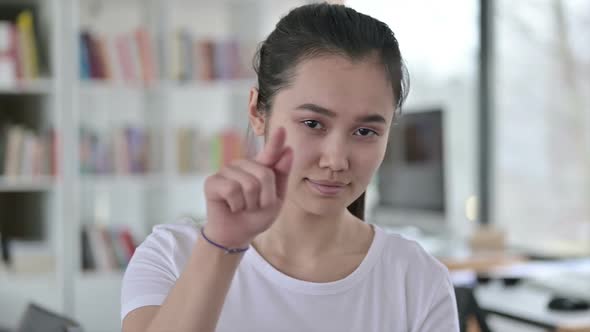 Portrait of Young Asian Woman Pointing at Camera and Inviting