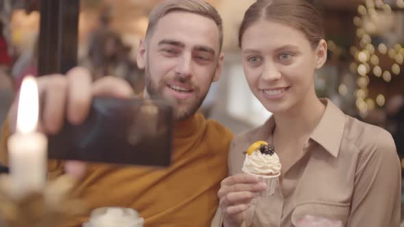 Pair of Young People Making Selfie