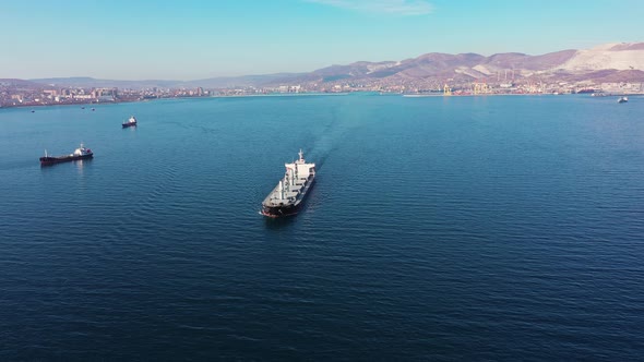 Flycam Films Long White Freight Vessel Crossing Clear Water