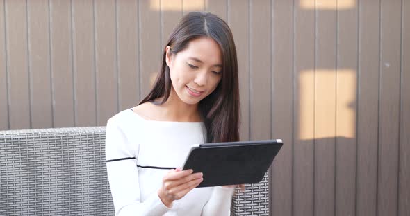 Woman watching on digital tablet computer