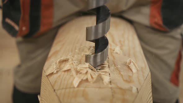 Drill a Hole in a Wooden Bar Closeup Shavings