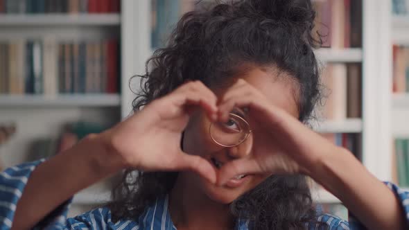 Young Indian Woman Shows Gesture in Form Heart Symbolizing Volunteer Activities