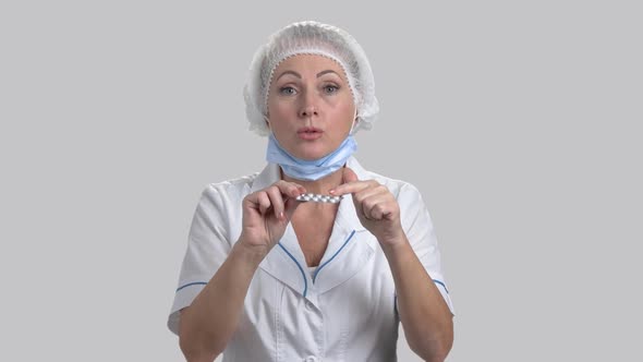 Confident Female Doctor Holding Pills.