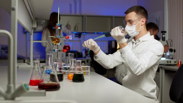 Young Scientist Mixing Colored Liquids