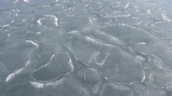 Aerial view of floating ice floes in the sea, the onset of spring, the concept of global warming