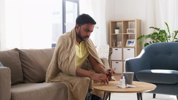 Sick Man Pouring Antipyretic Medicine To Spoon