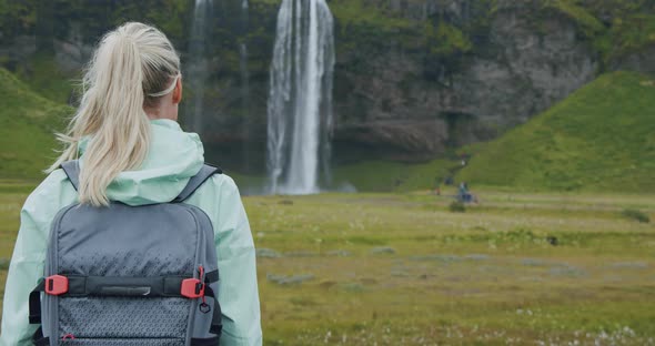 Rear View of Woman in Front of Seljalandsfoss Waterfall Iceland