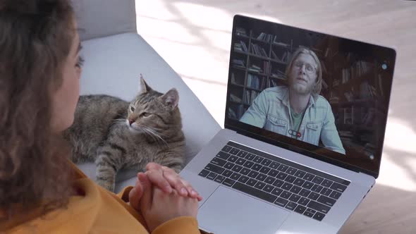 Online Male Teacher Talking on Video Call with Student at Home on Laptop