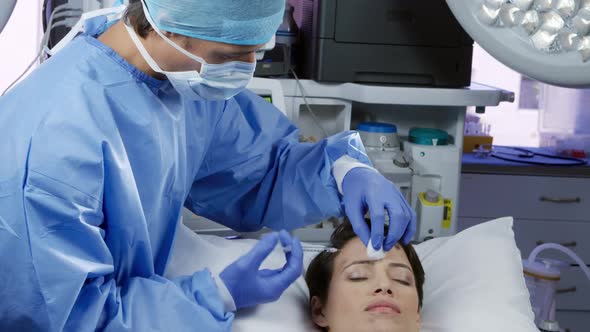 Patient and surgeon during a cosmetic procedure