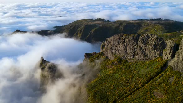 View of river valley with steep stony slopes of mountain ranges; rocky peaks and clouds; climbing an