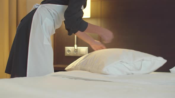 Housemaid Make a Bed and Best a Pillow in Hotel Room 